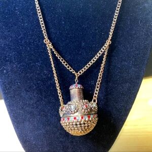 Amulet necklace with turquoise and coral colored stones
